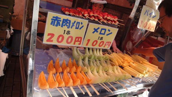 pineapple and melon on a stick for 100 and 200 yen respectively